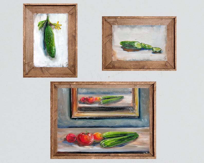 May include: Three framed oil paintings featuring fresh produce. One painting shows a whole cucumber with a yellow flower. Another depicts sliced cucumbers. The third painting displays tomatoes and cucumbers.