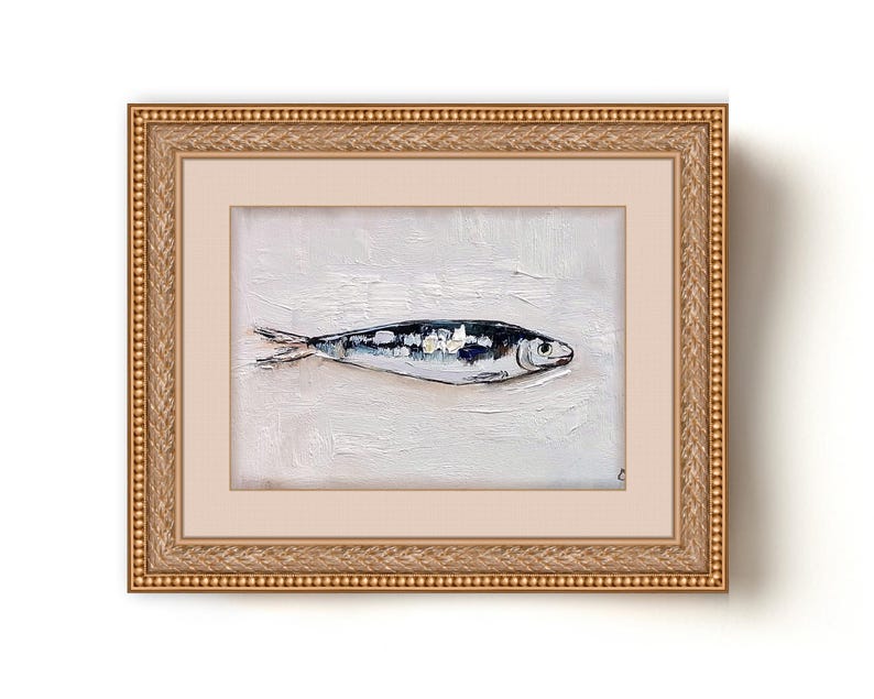 May include: Oil painting of a fish in a gold frame. The fish is painted in shades of blue, white, and black against a textured white background. The frame is ornate with a gold finish. The artwork is a still life.