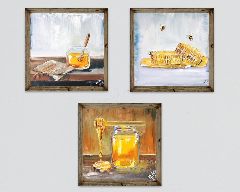 May include: Three framed paintings depicting honey-related scenes. One shows a jar of honey with a dipper, another features honeycomb with bees, and the last shows a honey dipper and jar. The paintings have a rustic, warm color palette.