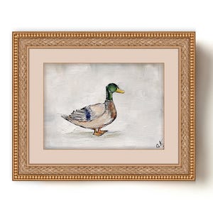 May include: A framed painting of a mallard duck with a green head and brown and white feathers. The duck is standing on a white background. The painting is in a gold frame with a decorative border. The artist's signature is in the bottom right corner of the painting. Mallard duck painting original miniature art Vintage duck oil painting farmhouse kitchen wall art country decor duck hunting gift 4x6