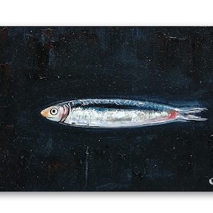 May include: A painting of a silver fish with a red stripe on a black background. The fish is swimming to the right. The artist's initials 'O.K.' and the year '23' are in the bottom right corner of the painting. Sardine art original painting Sardines still life oil painting miniature Anchovy fish painting French country kitchen art 4x6