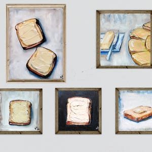 May include: Five framed paintings of toast with butter. The paintings feature various compositions, including two slices of toast, a single slice, and a plate of toast. The artwork uses a palette of warm browns, yellows, and whites.