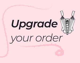 May include: A light pink background with the words "Upgrade your order" in black. A white corset illustration with black lacing is on the right side. A pink thorny vine design curves around the text.