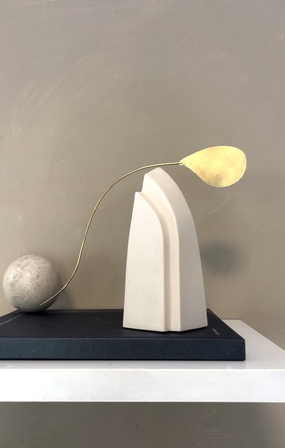 A hand-assembled tabletop standing mobile that actually balances and sways — quiet, meditative kinetic art with a gallery feel.