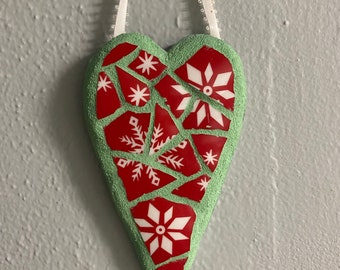 Heart shaped mosaic with red snowflake pattern. Red ribbon for hanging.