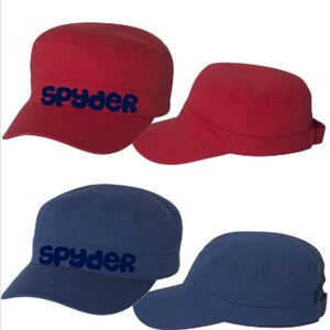 May include: Two pairs of military style caps. One pair is red and the other is blue. Both pairs have the word "Spyder" embroidered on the front in navy blue.