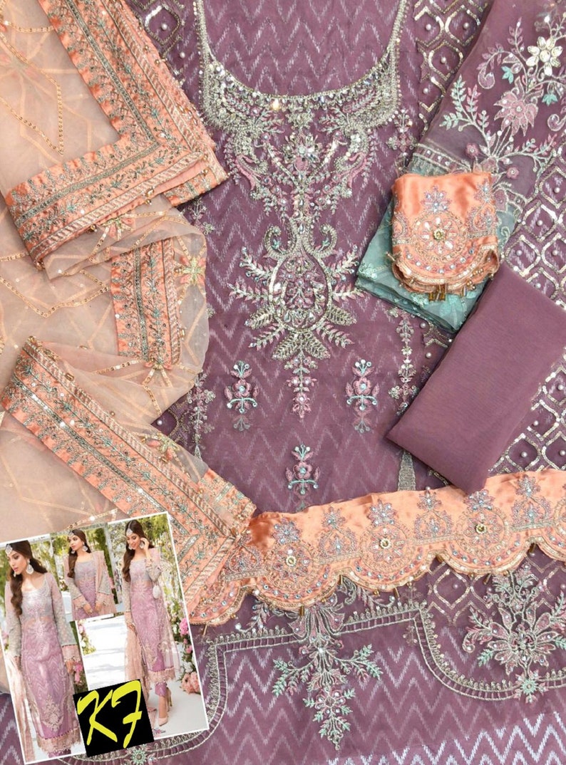 May include: A formal, lavender-colored embroidered dress with intricate silver and pearl embellishments. The dress features a detailed neckline, a matching scarf, and a peach-colored trim. A smaller image in the corner shows the dress being worn.