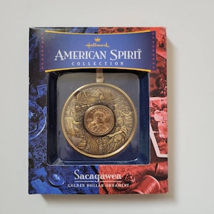 SACAGAWEA~AMERICAN SPIRIT Collection~Hallmark~Golden Dollar Ornament w/Certificate Of Authenticity and Tri-Fold  Brochure~Dated 2000