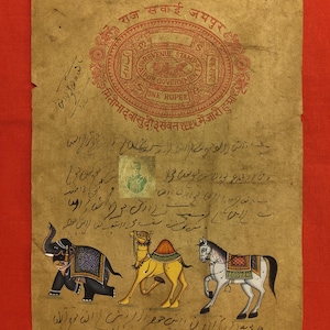 May include: Antique Indian artwork on aged paper, featuring a red Jaipur Revenue Stamp and handwritten text. The artwork depicts a black elephant, a yellow camel, and a white horse, all adorned with decorative elements. The background is a solid red.