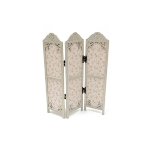May include: A white three-panel room divider with a floral pattern on each panel. The divider has a decorative carved design at the top of each panel.
