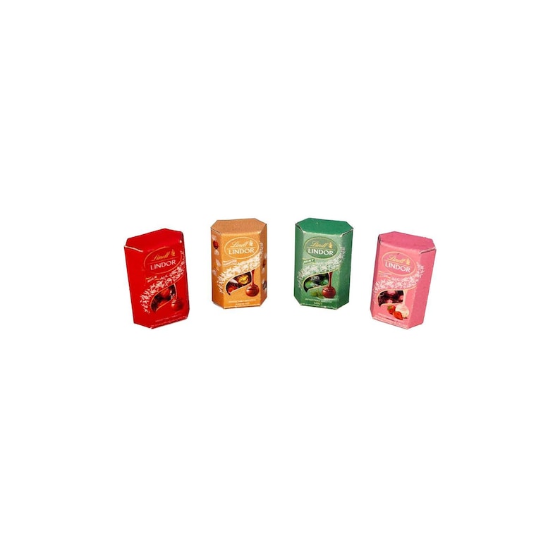 May include: Four boxes of Lindor chocolate candies in red, gold, green, and pink. Each box features a different cherry-themed design. The boxes are rectangular with a hexagonal top and the Lindor logo.