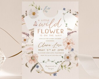 May include: A baby shower invitation with a watercolor illustration of a onesie surrounded by flowers. The text reads "A little wild flower is on the way!"  Join us for a baby shower honoring Clara Love. May 5th at 2 PM. 96 Ocean View Cafe, Palm Beach. RSVP to Lia at 355-456-478. Registered at Target.