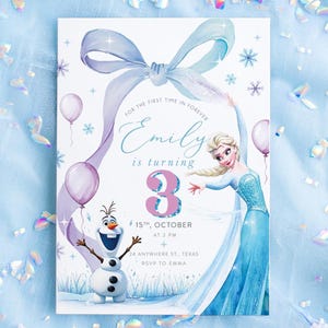 May include: A birthday invitation featuring a watercolor illustration of Elsa from Frozen. The invitation includes the text "Emily is turning 3" with event details. The design incorporates a light blue bow, snowflakes, and balloons.