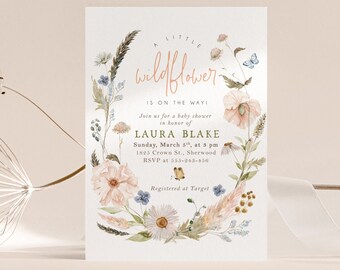 May include: A baby shower invitation with a watercolor illustration of wildflowers, butterflies, and a wreath. The text reads "A little wildflower is on the way! Join us for a baby shower in honor of Laura Blake. Sunday, March 5th, at 3 pm. 1825 Crown St., Sherwood. RSVP at 555-243-456. Registered at Target. Wisemonkey designs."