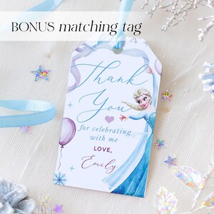 May include: A white gift tag with a blue ribbon, featuring a watercolor illustration of a princess in a blue dress. The tag reads "Thank You" and includes the text "for celebrating with me, LOVE, Emily."