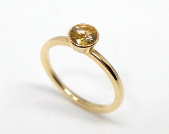 Simple gold ring with yellow sapphire, 14K gold with 4mm sapphire in desired size, engagement ring from the series "Lu" by Torbjörn Grönlund