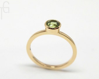 Gold ring with peridot, 14K yellow gold with light green gemstone in desired size, engagement ring from the series "Lu" by Torbjörn Grönlund