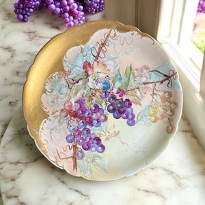 Plato decorativo Jean Pouyat Limoges con diseño de hojas de vid.