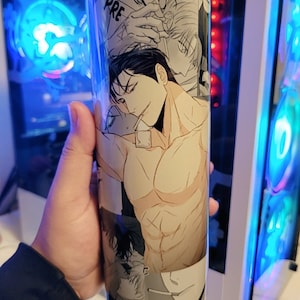 May include: A stainless steel tumbler with a black and white anime illustration featuring a shirtless man with a muscular physique. The illustration includes the word "PRE" in the background.
