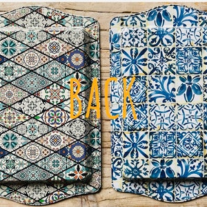 May include: Two rectangular serving trays with a decorative tile pattern. The tray on the left has a blue, green, and white pattern. The tray on the right has a blue and white pattern. The word "BACK" is written in orange letters on the image.