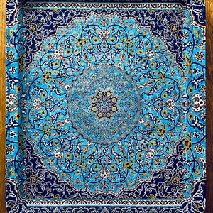 May include: A blue and gold metal serving tray with an intricate floral pattern. The tray has a raised rim and a slightly curved edge.