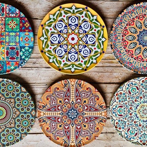 May include: Six decorative ceramic plates with intricate geometric patterns in shades of blue, green, red, yellow, and white. The plates feature a variety of designs, including paisley, floral, and geometric motifs.