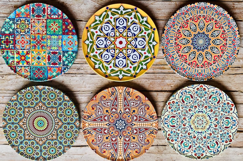 May include: Six decorative ceramic plates with intricate geometric patterns in shades of blue, green, red, yellow, and white. The plates feature a variety of designs, including paisley, floral, and geometric motifs.