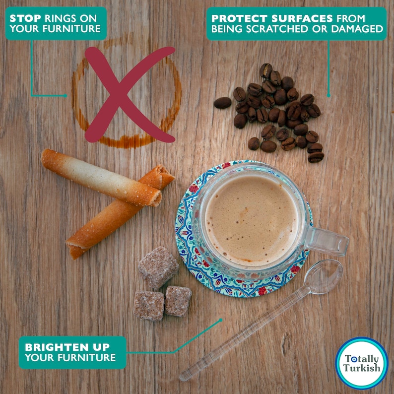 May include: A close-up of a wooden table with a cup of coffee, sugar cubes, and two long, thin biscuits. The coffee cup is on a colourful coaster. The text "Stop rings on your furniture" is at the top left of the image. The text "Protect surfaces from being scratched or damaged" is at the top right of the image. The text "Brighten up your furniture" is at the bottom left of the image. The text "Totally Turkish" is at the bottom right of the image.