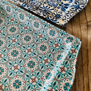 May include: Two decorative trays with a blue and white tile pattern. The top tray has a more intricate design with a yellow background. The bottom tray has a simpler design with a white background.