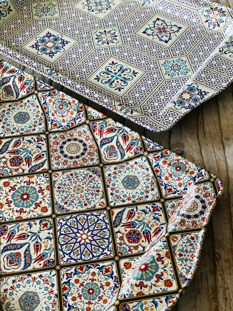 May include: Two decorative trays with a white background and intricate blue, red, and gold patterned designs inspired by traditional Turkish tiles.