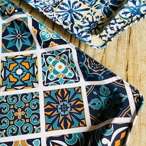 May include: Two metal serving trays with a blue and white geometric tile pattern. The trays are made of metal and have a white background with blue and white geometric designs.