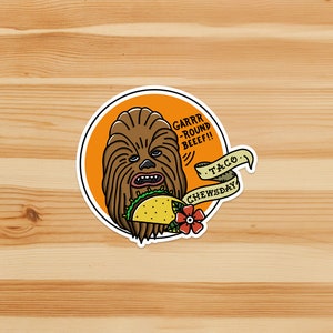 May include: A round sticker with a cartoon illustration of Chewbacca eating a taco. The text on the sticker reads "GARRR -ROUND BEEF!!" and "TACO CHEWSDAY".