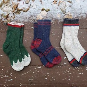 May include: Three pairs of wool socks in different colors and patterns. The socks are green with white trim, blue with red and white stripes, and white with red and green stripes.