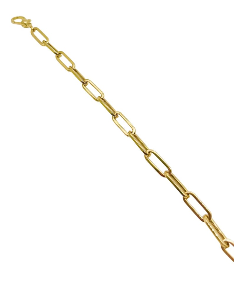 May include: A gold chain bracelet with a simple, linked design.