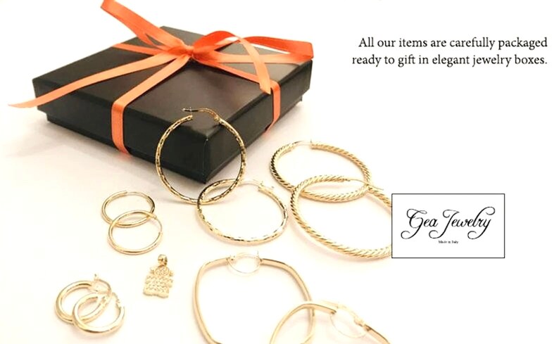 K&ouml;nnte beinhalten: Ein Set goldener Creolen in verschiedenen Gr&ouml;&szlig;en und Stilen, verpackt in einer schwarzen Geschenkbox mit einem korallenfarbenen Band. Die Ohrringe sind bereit zum Verschenken. Die Box enth&auml;lt auch einen kleinen goldenen Anh&auml;nger mit einem strukturierten Design. Das Bild enth&auml;lt den Text "Gea Jewelry".
