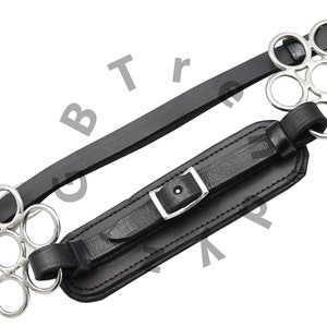 May include: Black leather horse bit with a silver buckle and two silver rings with multiple smaller rings.