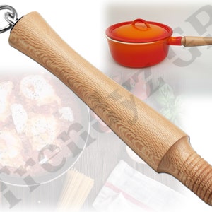 May include: A wooden pot handle replacement with a metal ring at the top. The handle is light brown with a wood grain pattern. The handle is threaded at the bottom.