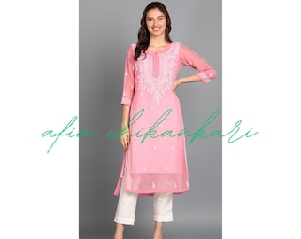 May include: A pink long-sleeved kurta with white embroidery. The kurta has a round neckline and a side slit. The model is wearing white pants and white sandals.