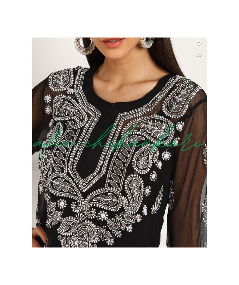 May include: Black sheer tunic with silver embroidery and embellishments. The embroidery features paisley and floral patterns.