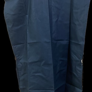 May include: A dark blue sleeveless tunic top with a scoop neck.