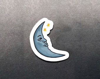 May include: A blue crescent moon sticker with a human face and three yellow stars.