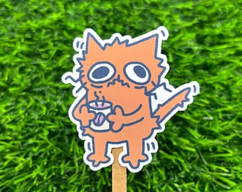 May include: A sticker of an orange cat with a worried expression holding a cup of coffee. The cat is outlined in black and has a white background.
