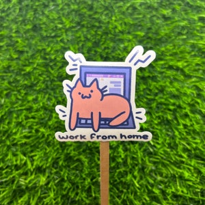 May include: A sticker with a cartoon cat sitting on a laptop with the text "Work from home".