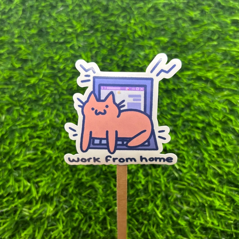 May include: A sticker with a cartoon cat sitting on a laptop with the text "Work from home".