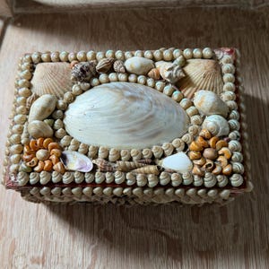 May include: A set of three ceramic mugs with a speckled, matte finish. The mugs are in shades of cream, light gray, and dark gray. Each mug has a simple, minimalist design, perfect for coffee or tea.