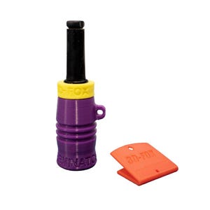 May include: A purple and yellow predator call with a black mouthpiece and a small orange clip. The call has the word "ELIMINATOR" printed on it. The orange clip has the text "3D-FOX" printed on it.