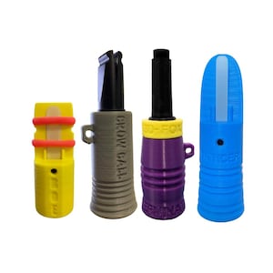 May include: Four colorful game calls are displayed against a white background. The calls are yellow, gray, purple, and blue. The yellow call has red accents and the text "GOOSE". The gray call has the text "CROW CALL". The purple call has the text "SO-FOX". The blue call has the text "SENTICER".