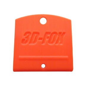 May include: Bright orange plastic tool with the embossed text "3D-FOX". The tool has a rounded top with a hole and a smaller hole at the bottom. A horizontal line is embossed across the center of the tool.