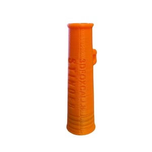 May include: An orange 3D-printed cylindrical object with the text "3D ROYAL BINDER" printed vertically. The object has a small handle-like protrusion on the side and a flared base. The item is set against a white background.