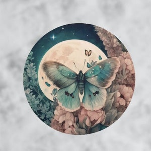 May include: Circular artwork featuring a teal butterfly with detailed wings, set against a full moon and a starry night sky. The butterfly is positioned above pink and purple flowers, creating a whimsical, nature-inspired design.